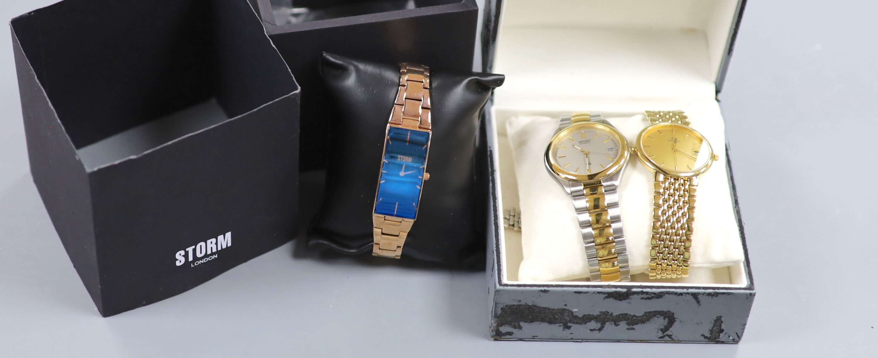 A gentleman's modern steel and gold plated Omega De Ville quartz wrist watch, a Storm watch and a Seiko quartz watch.